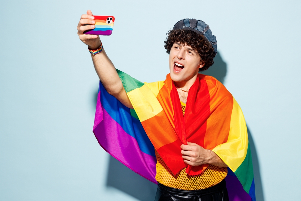 young,happy,gay,latin,man,wear,hat,wrapped,in,flag
