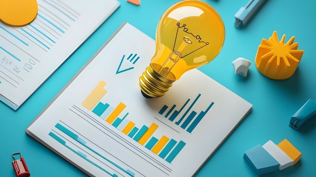 Gráficos financieros con bombilla simbolizando ideas y análisis