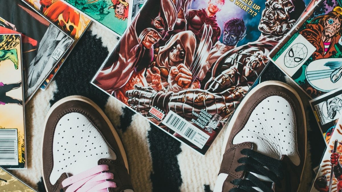 Zapatillas junto a varios cómics sobre alfombra